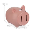 Halványrózsaszínű malacpersely az orrában kialakított bedobónyílással papírpénznek és érméknek külső méretekkel