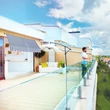 Penthouse lakás erkélyére szerelt kék-fehér csíkos ejtőkaros árnyékoló