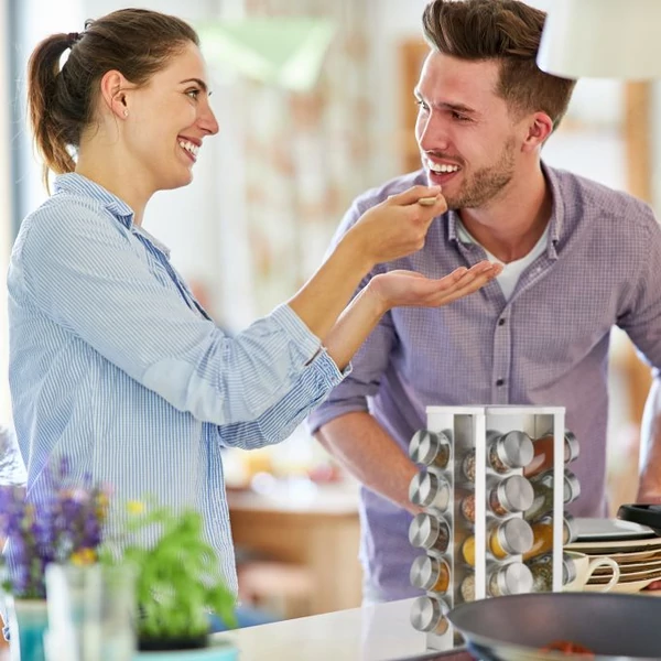 Főzés közben egy pár az előttük a konyhapulton elhelyezett kerket 20 db-os fűszertartó állvánnyal