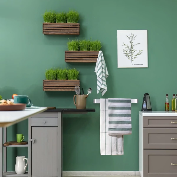 rozsdamentes acél törölközőtartó zöld falra felszerelve